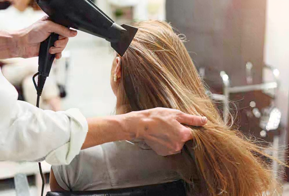 Long hair being blow-dried by a professional hairstylist